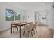 Cozy dining area with modern table setting, natural light, and wood floors at 4420 Lake Lawne Ave, Orlando, FL 32808
