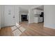 Bright foyer featuring hardwood floors and a view of the living room with a fireplace and the kitchen at 4420 Lake Lawne Ave, Orlando, FL 32808