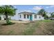 Charming single-story home with a well-maintained lawn, white fence and a blue front door at 4420 Lake Lawne Ave, Orlando, FL 32808