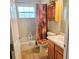 Standard bathroom featuring a shower-tub combination, vanity with storage, and tiled floor at 4471 Treasure Cay Rd, Tavares, FL 32778