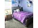 Bright bedroom with a queen bed, hardwood floors, and natural light streaming through the window at 4471 Treasure Cay Rd, Tavares, FL 32778