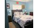 Cozy bedroom featuring a queen-sized bed with a floral-patterned comforter and matching nightstands at 4471 Treasure Cay Rd, Tavares, FL 32778