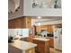 Bright kitchen offering an island, oak cabinetry, and tile flooring, creating a warm cooking environment at 4471 Treasure Cay Rd, Tavares, FL 32778
