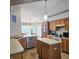 Functional kitchen featuring an island, ample cabinetry, and stainless steel appliances, blending convenience with style at 4471 Treasure Cay Rd, Tavares, FL 32778