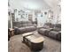 Spacious living room with plush seating, elegant coffee table, and ample natural light, great for entertaining at 4471 Treasure Cay Rd, Tavares, FL 32778
