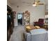 Relaxing living area with plush recliner, large TV cabinet, and ceiling fan, perfect for unwinding at 4471 Treasure Cay Rd, Tavares, FL 32778