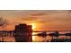 Gorgeous waterfront view with a house on stilts, with many boats, during sunset at 4471 Treasure Cay Rd, Tavares, FL 32778