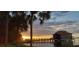Charming waterfront building with a dock and sunset views, framed by palm trees, offering serene waterfront living at 4471 Treasure Cay Rd, Tavares, FL 32778