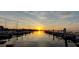 Peaceful waterfront marina scene showcasing boats at sunset, reflecting in the tranquil water, a perfect spot for relaxation at 4471 Treasure Cay Rd, Tavares, FL 32778