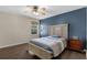 Bedroom with hardwood floors, a blue accent wall, and a comfortable bed at 480 Buckhorn Dr, Winter Springs, FL 32708