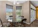 Bright breakfast nook with a glass table, chairs, and a view of the pond at 480 Buckhorn Dr, Winter Springs, FL 32708