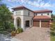 Elegant two-story home boasting a tile roof and a paver driveway leading to a three-car garage at 480 Buckhorn Dr, Winter Springs, FL 32708