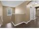 Upstairs hallway with hardwood floors, a window, and doorways leading to bedrooms at 480 Buckhorn Dr, Winter Springs, FL 32708