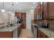 Well-equipped kitchen featuring granite counters, stainless steel appliances, and wooden cabinets at 480 Buckhorn Dr, Winter Springs, FL 32708