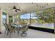 Spacious screened lanai featuring a ceiling fan and stunning views of the lake at 480 Buckhorn Dr, Winter Springs, FL 32708