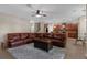 Spacious living area with tile floors, plush rug, leather sofa, and ceiling fan at 480 Buckhorn Dr, Winter Springs, FL 32708