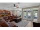 Spacious living room open to kitchen and eat in area with large sofa, white rug and access to patio at 480 Buckhorn Dr, Winter Springs, FL 32708