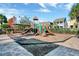 Community playground with slides and a climbing structure is surrounded by greenery at 480 Buckhorn Dr, Winter Springs, FL 32708