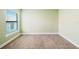 Empty bedroom featuring neutral carpet and a window with blinds at 4940 Tennessee Lake Dr, Auburndale, FL 33823
