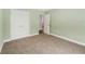 Bedroom with neutral paint, carpeted floor, baseboard trim, and double doors for closet storage at 4940 Tennessee Lake Dr, Auburndale, FL 33823