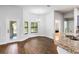 Bright breakfast nook featuring bay windows, a modern light fixture, and wood floors at 4940 Tennessee Lake Dr, Auburndale, FL 33823