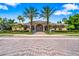 A view of the community clubhouse featuring elegant design, landscaping, and brick-paved path at 4940 Tennessee Lake Dr, Auburndale, FL 33823