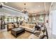 Inviting clubhouse lounge area with comfortable seating, chandeliers, and views of the billiard room at 4940 Tennessee Lake Dr, Auburndale, FL 33823