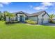 Beautiful single-Gathering home featuring a well-manicured lawn, stone-lined garden, and charming exterior at 4940 Tennessee Lake Dr, Auburndale, FL 33823