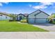 A charming single-Gathering home with a three-car garage and well-maintained landscaping at 4940 Tennessee Lake Dr, Auburndale, FL 33823