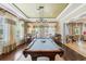 Well-decorated game room featuring a pool table, chandelier, and seating around tables near windows at 4940 Tennessee Lake Dr, Auburndale, FL 33823