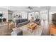 Bright, modern living room featuring wood floors, neutral furniture, and an open floor plan at 4940 Tennessee Lake Dr, Auburndale, FL 33823