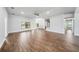 Spacious living room featuring wood-look tile flooring, a ceiling fan, and large windows for natural light at 4940 Tennessee Lake Dr, Auburndale, FL 33823