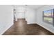 Open living room featuring wood-look tile flooring and a large window with blinds at 4940 Tennessee Lake Dr, Auburndale, FL 33823