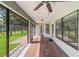Screened patio with tile floors, ceiling fan, and a view of the manicured backyard and landscaping at 4940 Tennessee Lake Dr, Auburndale, FL 33823