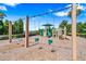 A community playground with swings, slides, and various play structures on a wood chip ground at 4940 Tennessee Lake Dr, Auburndale, FL 33823