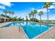A community pool featuring lounge chairs and palm trees with beautiful pavers surrounding the area at 4940 Tennessee Lake Dr, Auburndale, FL 33823