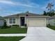 Charming single-story home with a well-manicured lawn, two car garage, and neutral exterior paint at 5147 Marshelder St, Apopka, FL 32712