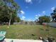 Spacious backyard featuring a tall wooden fence providing privacy, and a well-manicured lawn at 56 Redwood Rd, Ocala, FL 34472