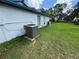Exterior view of the home's back side, highlighting the AC unit and spacious yard at 56 Redwood Rd, Ocala, FL 34472