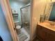 Bathroom featuring a glass shower with seat, tiled floor, wood vanity, and a medicine cabinet at 56 Redwood Rd, Ocala, FL 34472