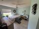 Comfortable bedroom features tile flooring, a ceiling fan, and a decorative mirror at 56 Redwood Rd, Ocala, FL 34472