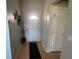 Bright entryway featuring a white front door, neutral walls, and hardwood floors at 56 Redwood Rd, Ocala, FL 34472