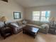 Cozy living room featuring a large sectional sofa, hardwood floors, and a large window at 56 Redwood Rd, Ocala, FL 34472