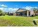 Large backyard featuring a screened lanai, perfect for outdoor entertaining and enjoying the Florida sunshine at 561 Vineyard Way, Poinciana, FL 34759