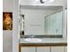 Bathroom with a large mirror, white cabinets, a single sink vanity, and a decorative shower curtain at 561 Vineyard Way, Poinciana, FL 34759