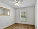 Well-lit bedroom with neutral carpet, a large window with plantation shutters, and a ceiling fan at 561 Vineyard Way, Poinciana, FL 34759