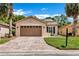Charming single-story home featuring a two-car garage, solar panels and a beautifully landscaped lawn at 561 Vineyard Way, Poinciana, FL 34759