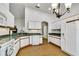 Traditional kitchen with white cabinets, wood-look flooring, and bright countertops, offering a functional and appealing space at 561 Vineyard Way, Poinciana, FL 34759