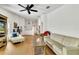 Spacious living room with vaulted ceilings, wood floors, neutral decor, and a ceiling fan at 561 Vineyard Way, Poinciana, FL 34759