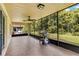 Spacious screened-in porch with tile flooring, a ceiling fan, and a grill, perfect for outdoor enjoyment at 561 Vineyard Way, Poinciana, FL 34759